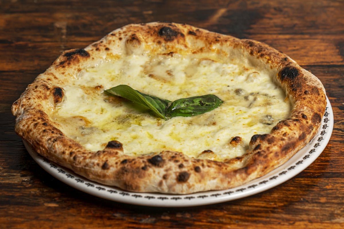 a pizza sitting on top of a wooden table